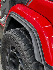 The fender flare extensions being used on a Jeep Wrangler driving off-road.