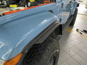 The fender flare extensions being used on a Jeep Wrangler driving off-road.