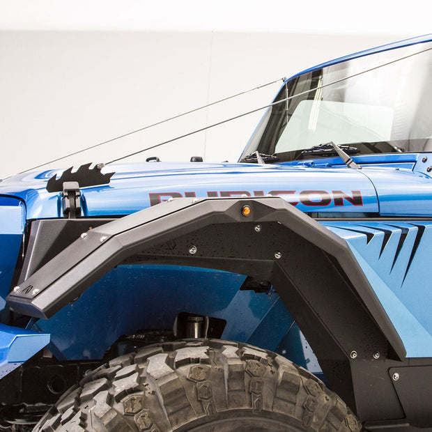 A Jeep Wrangler JL 2018-2022 with black steel front fender flares installed.